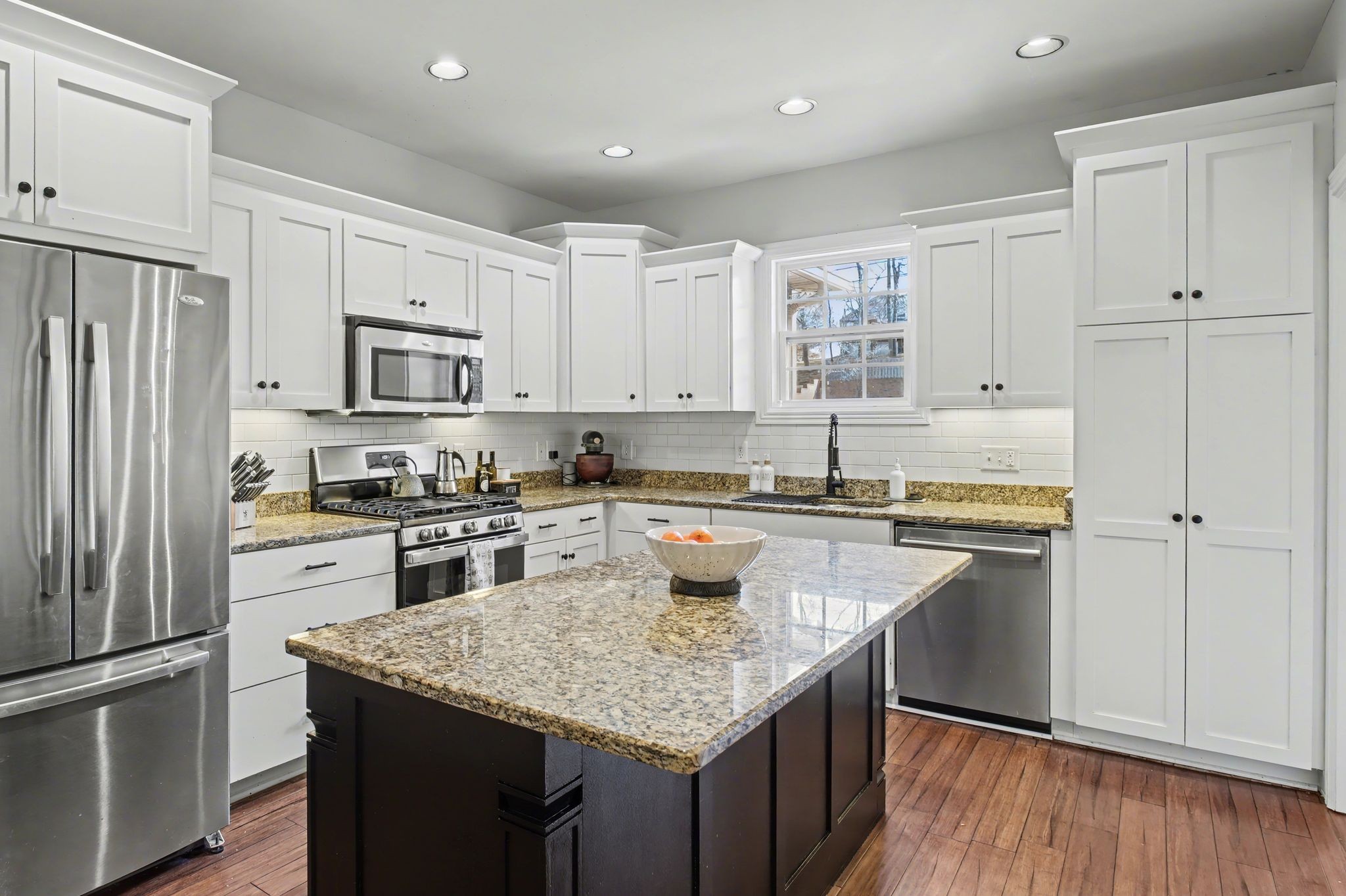 701 Deer Ridge Lane Lebanon, TN 37087 - Photo 16 of 41 a kitchen with kitchen island granite countertop a sink stove and refrigerator