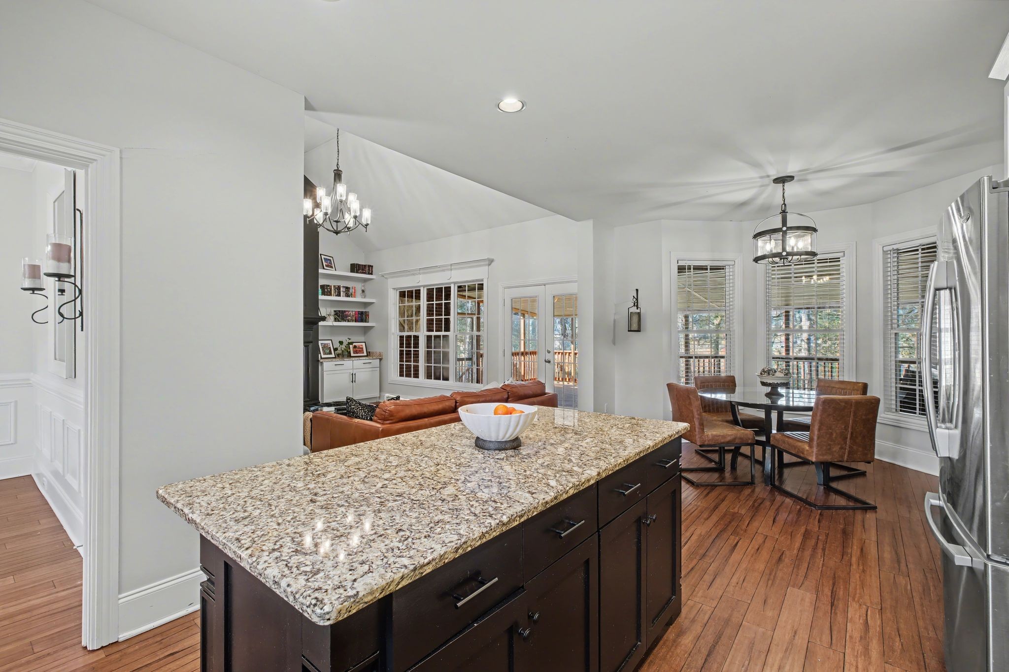 701 Deer Ridge Lane Lebanon, TN 37087 - Photo 19 of 41 a open kitchen with granite countertop a sink dishwasher a dining table and chairs with wooden floor