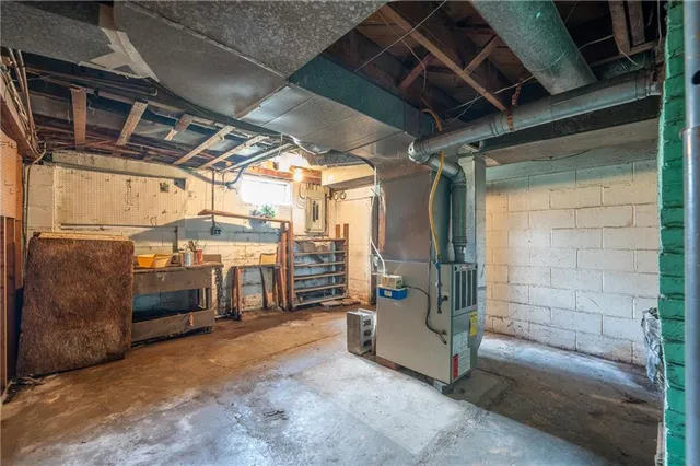 a view of a house with a floor to ceiling window and garden