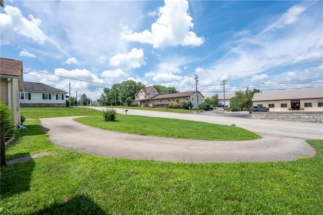 a view of a stadium that has a bunch of big trees