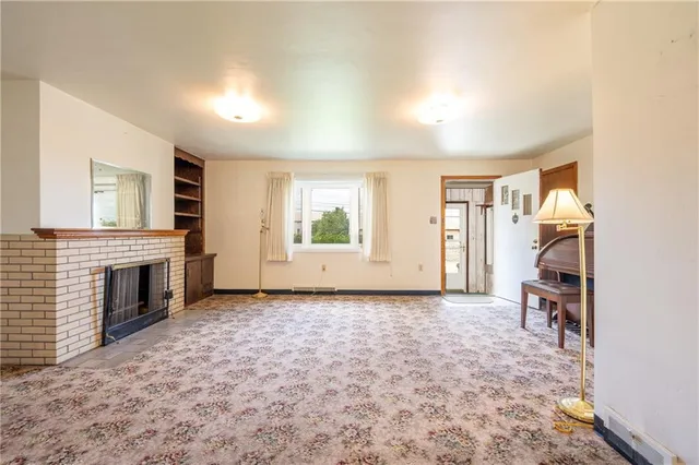a view of a livingroom with furniture and a fireplace