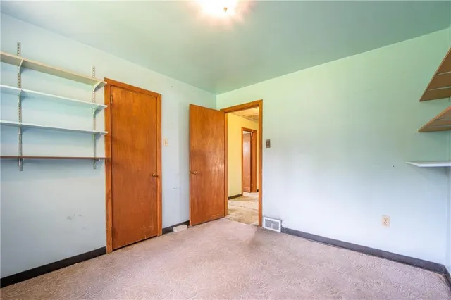 an empty room with windows and chandelier