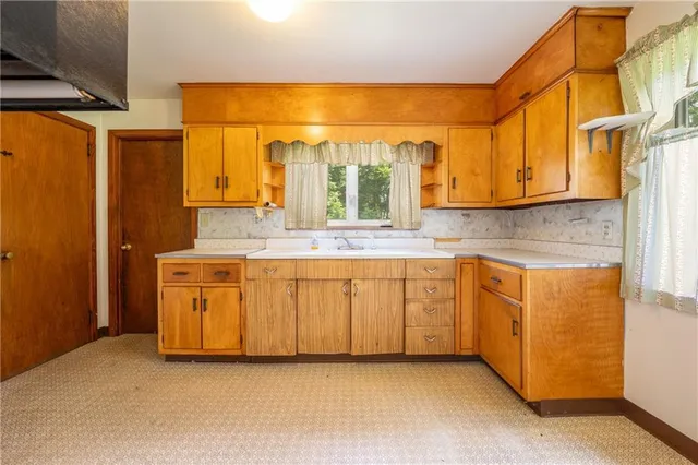 a bathroom with a granite countertop sink mirror and double