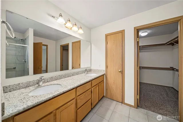 a spacious bathroom with a granite countertop sink and a mirror