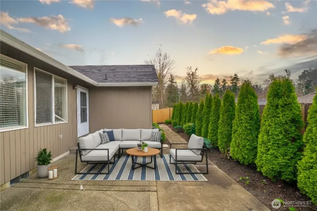a backyard of a house with table and chairs