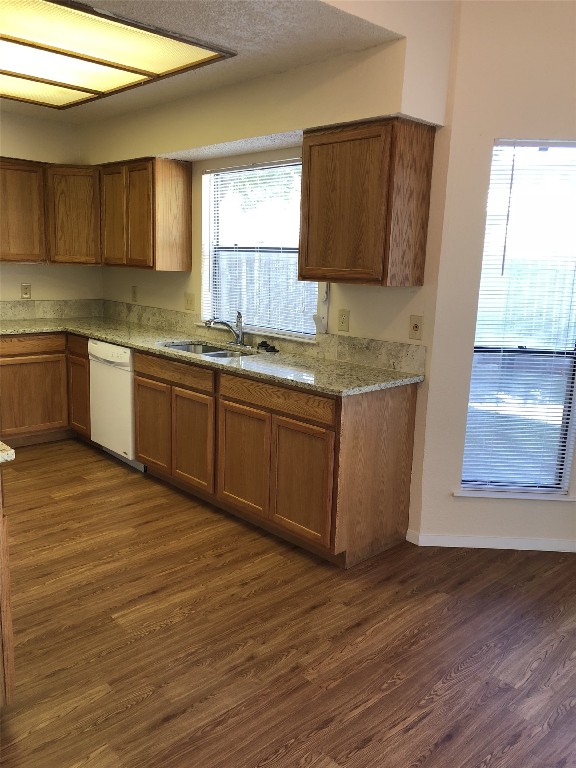 8300 Bradford Edward Cove, Unit B Austin, TX 78759 - Photo 4 of 15 a kitchen with stainless steel appliances granite countertop a sink and wooden cabinets