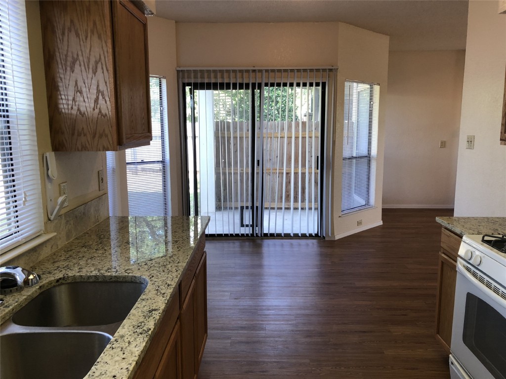 8300 Bradford Edward Cove, Unit B Austin, TX 78759 - Photo 5 of 15 a kitchen with granite countertop a stove and a sink