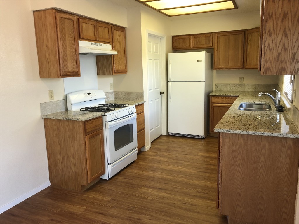 8300 Bradford Edward Cove, Unit B Austin, TX 78759 - Photo 7 of 15 a kitchen with a refrigerator sink and stove