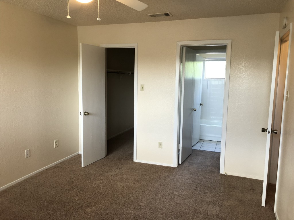 8300 Bradford Edward Cove, Unit B Austin, TX 78759 - Photo 10 of 15 an empty room with closet and a bathroom