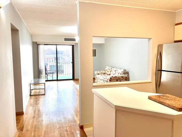 a kitchen with a sink a refrigerator and a window