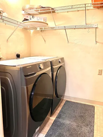 a view of a room with wooden floor and chandelier