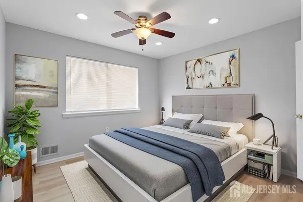 a bedroom with a bed and a potted plant