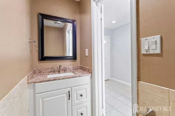 a bathroom with a sink vanity and a mirror