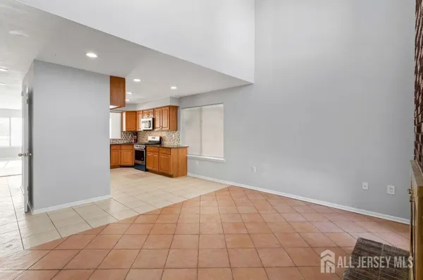 a view of a kitchen with furniture and an empty room