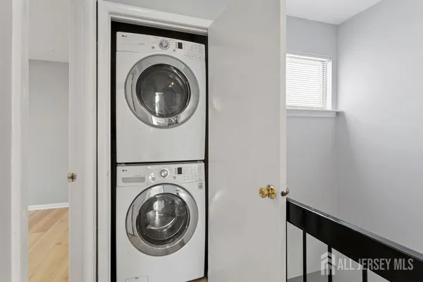 a view of a hallway with washer and dryer