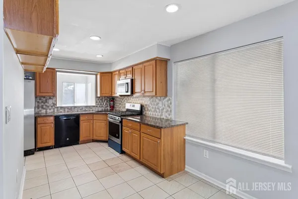 a kitchen with stainless steel appliances granite countertop a sink and cabinets