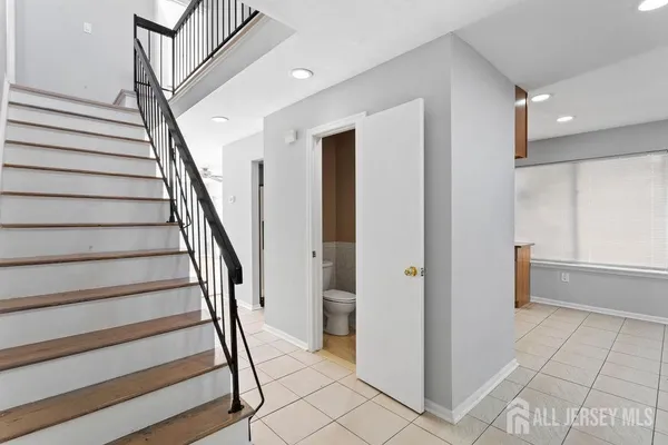a view of entryway with wooden floor and stairs