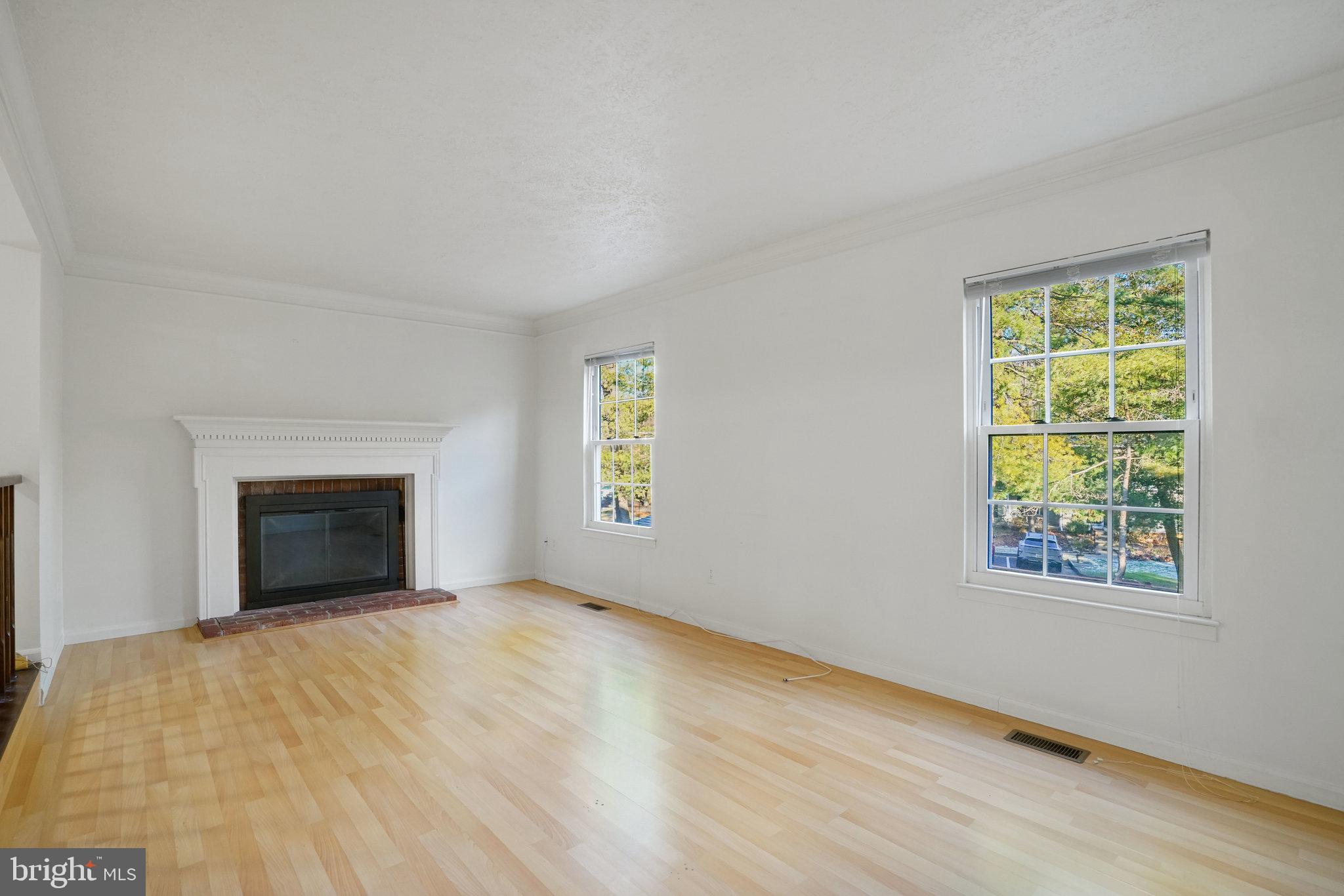 6515 Field Master Drive Springfield, VA 22152 - Photo 16 of 47 a view of an empty room with a window and a fireplace