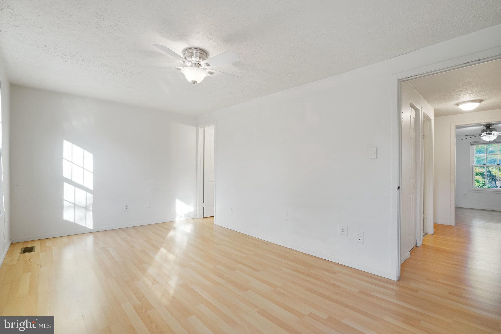 6515 Field Master Drive Springfield, VA 22152 - Photo 31 of 47 a view of an empty room with wooden floor and a window
