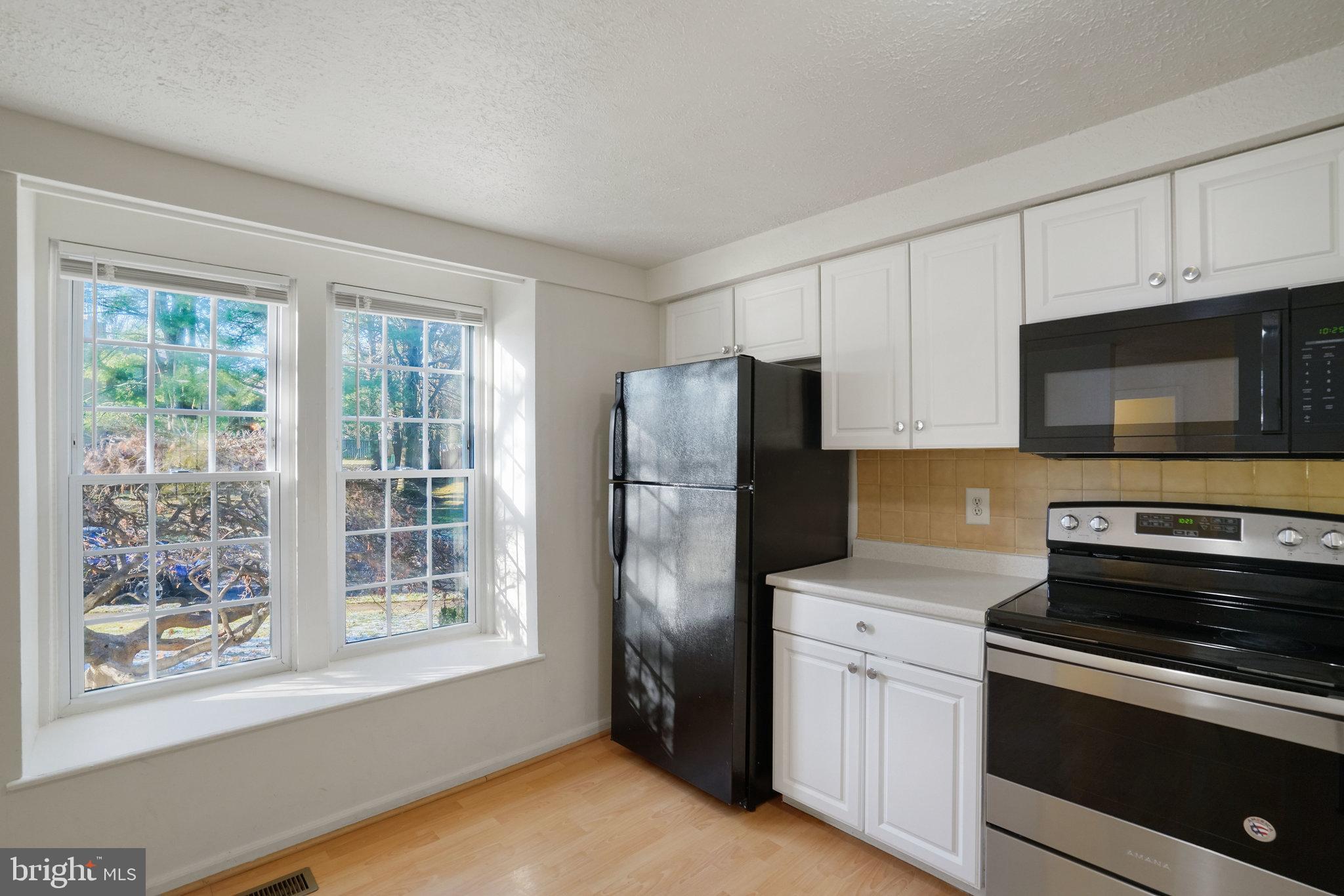 6515 Field Master Drive Springfield, VA 22152 - Photo 6 of 47 a kitchen with stainless steel appliances granite countertop a refrigerator stove and microwave