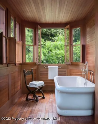a bathroom with a double vanity sink a mirror and a bathtub