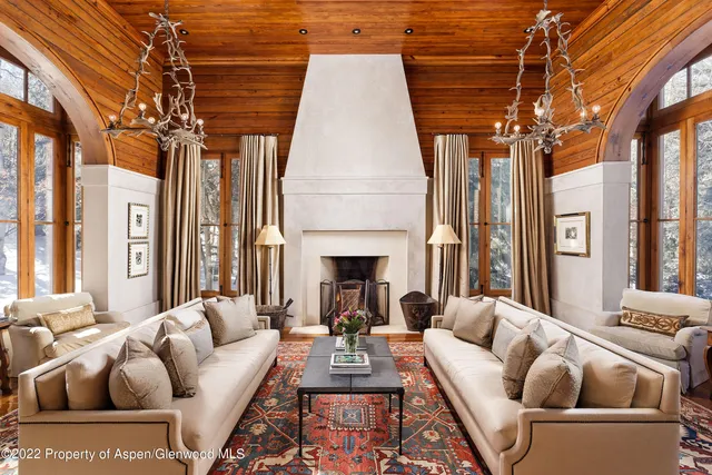 a living room with furniture a fireplace and a table