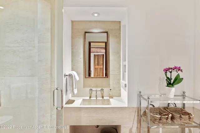 a spacious bedroom with a bed couch and a large window