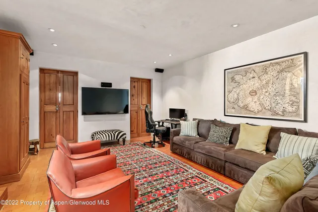 a view of a dining room with furniture and a book shelf