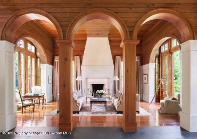 a dining room with furniture water view and large windows