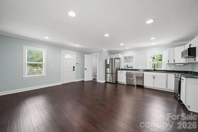 a view of kitchen with refrigerator sink and wooden floor