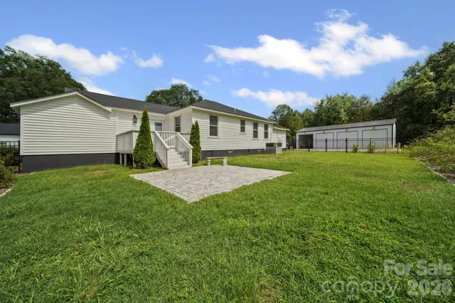 a view of a house with a yard and table