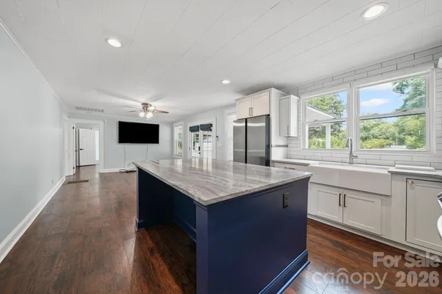 a kitchen with granite countertop a sink and cabinets