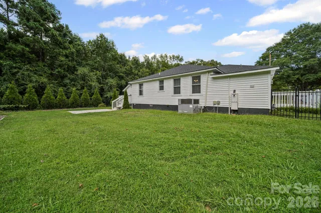 a view of a house with a yard and deck