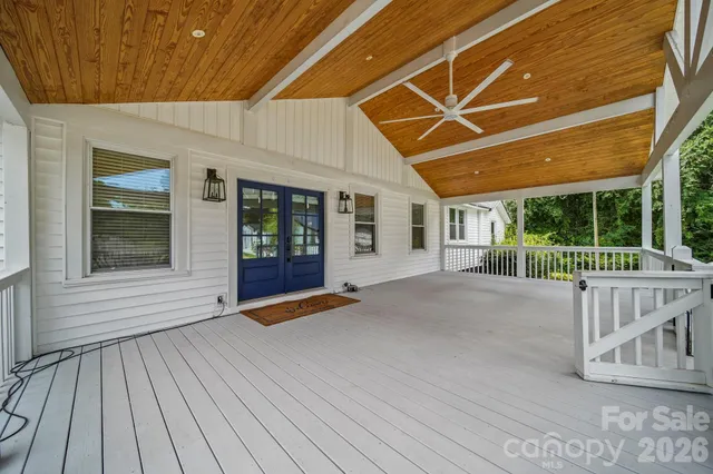 a view of a porch with wooden floor and fence