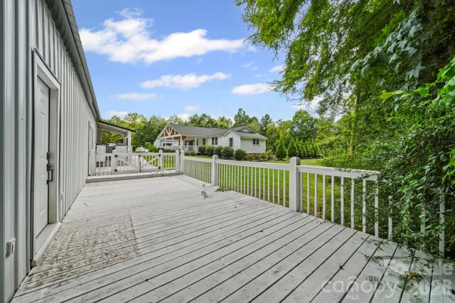 a view of balcony with wooden floor and fence