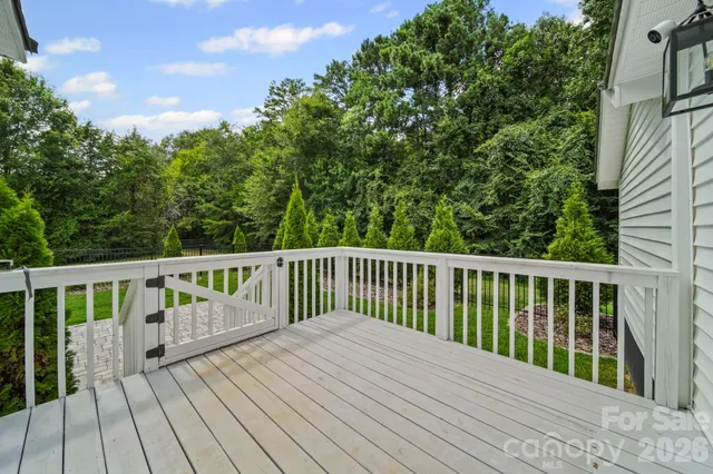 a view of balcony with wooden floor and fence