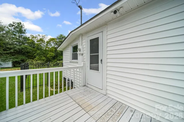 a balcony with wooden floor and fence