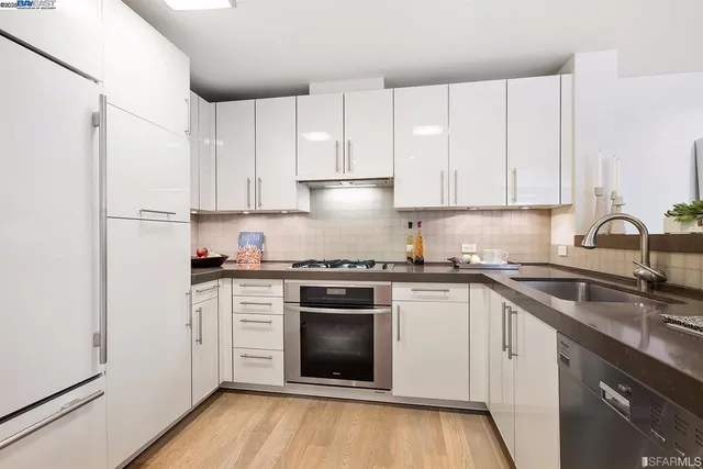 a kitchen with a sink cabinets and stainless steel appliances