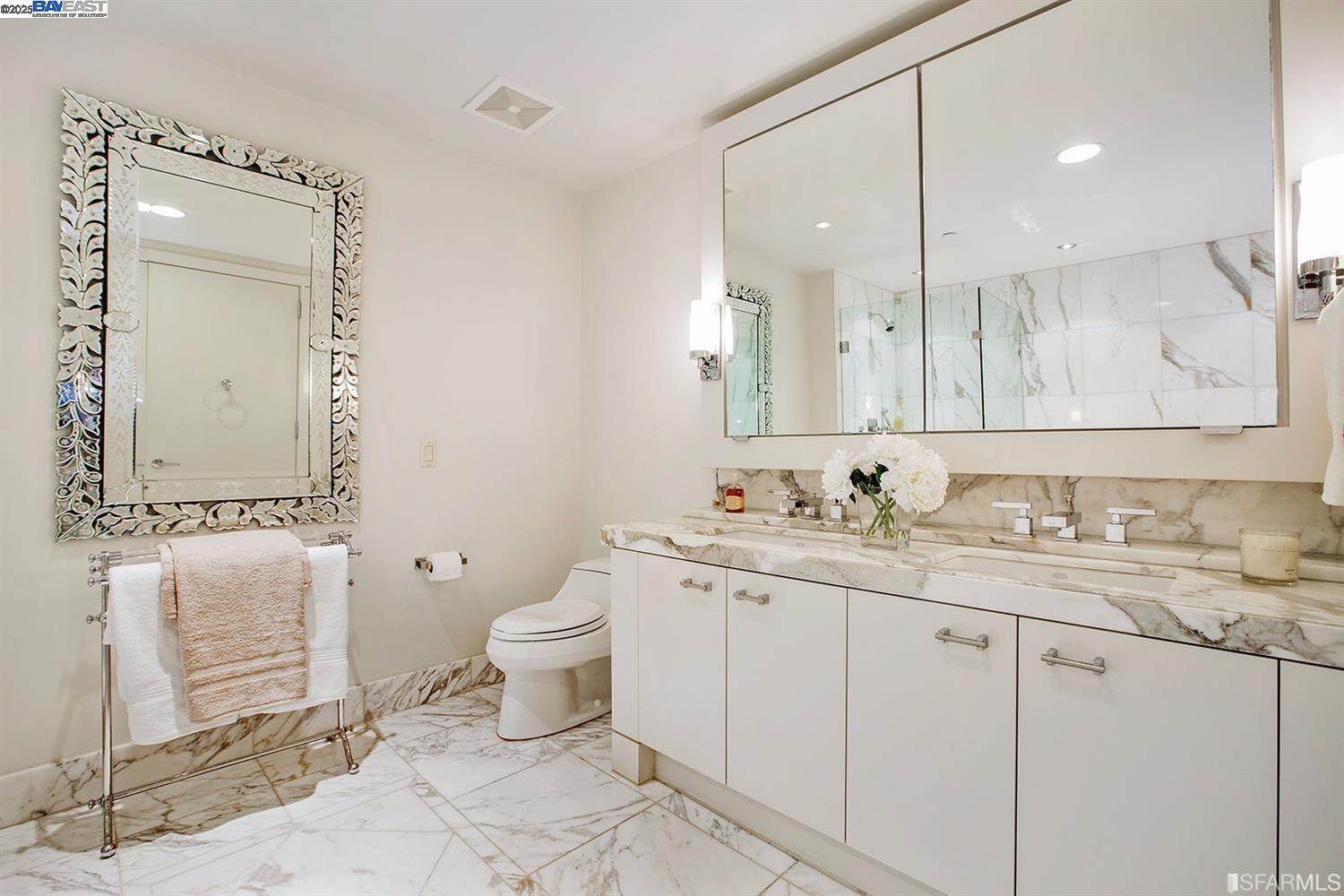 188 Minna, Unit 24F San Francisco, CA 94105 - Photo 9 of 11 a bathroom with a granite countertop sink mirror and toilet