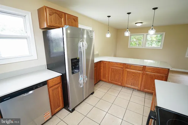 a kitchen with stainless steel appliances a refrigerator sink and microwave
