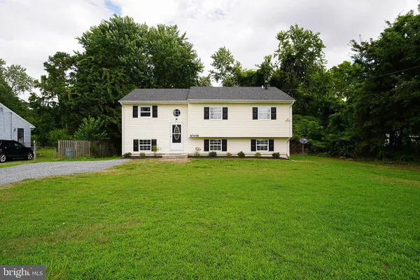 a front view of a house with a garden and porch