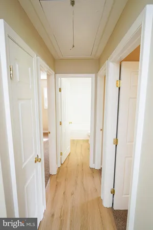 a view of hallway with wooden floor