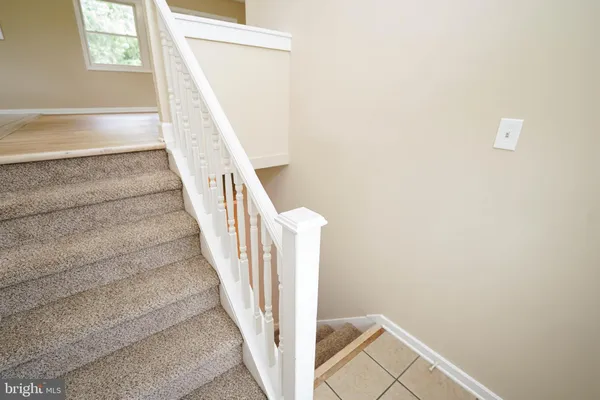 a view of staircase with white walls and a window