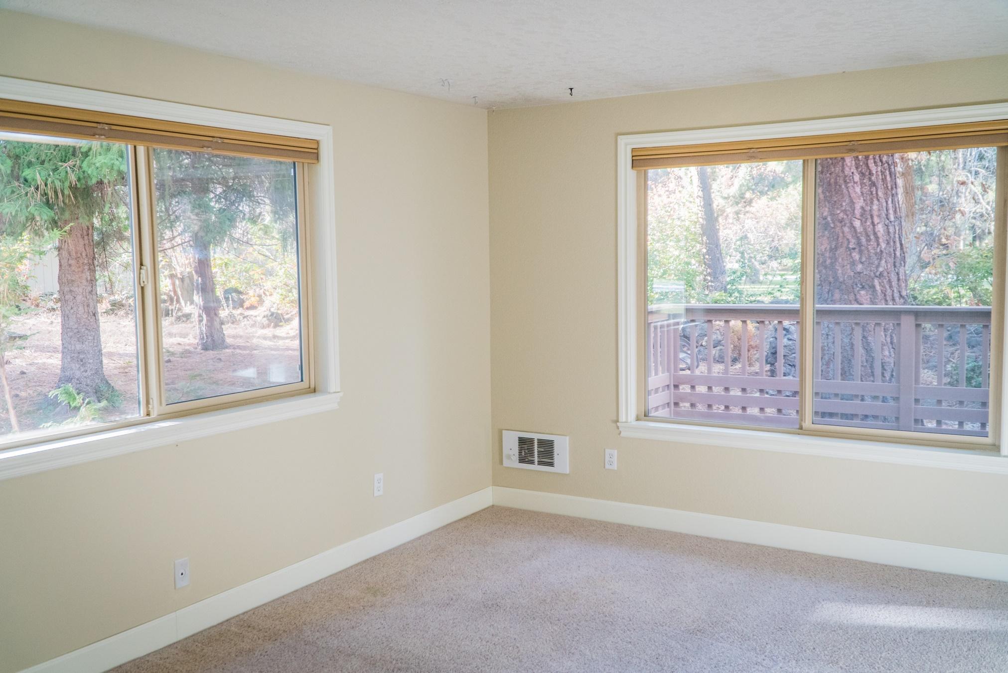 20380 Strawline Road Bend, OR 97702 - Photo 17 of 30 Master bedroom on the main level with privacy & green space out the windows.