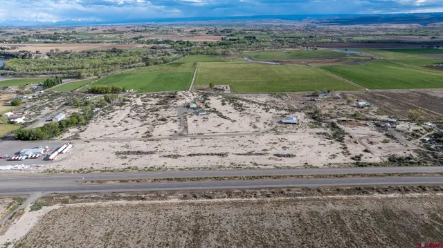 a view of a yard with wooden fence