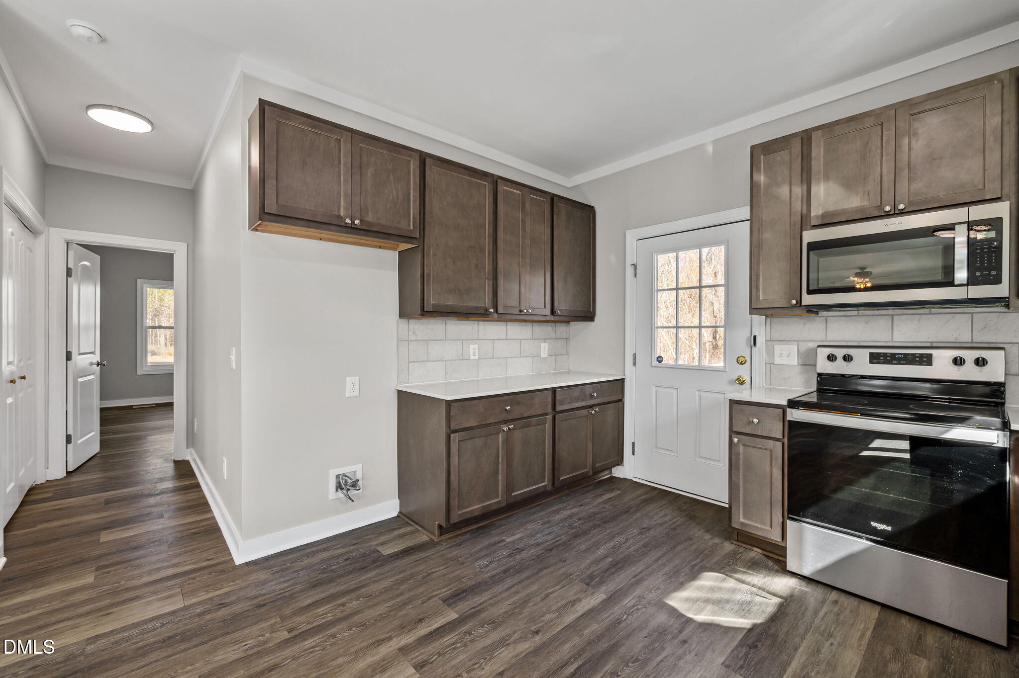 1108 Shelton Road Roxboro, NC 27573 - Photo 13 of 27 a kitchen with a sink wooden floor and stainless steel appliances
