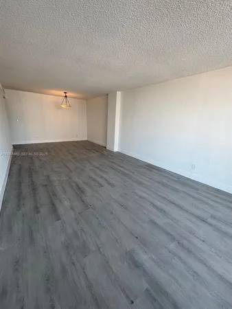 a view of an empty room and wooden floor