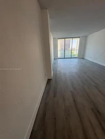 a view of wooden floor and windows in a room
