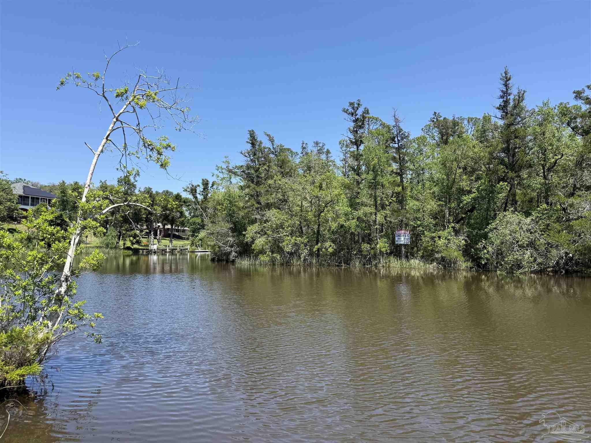 0 Broad Street Milton, FL 32570 - Photo 13 of 28 a view of a lake with houses