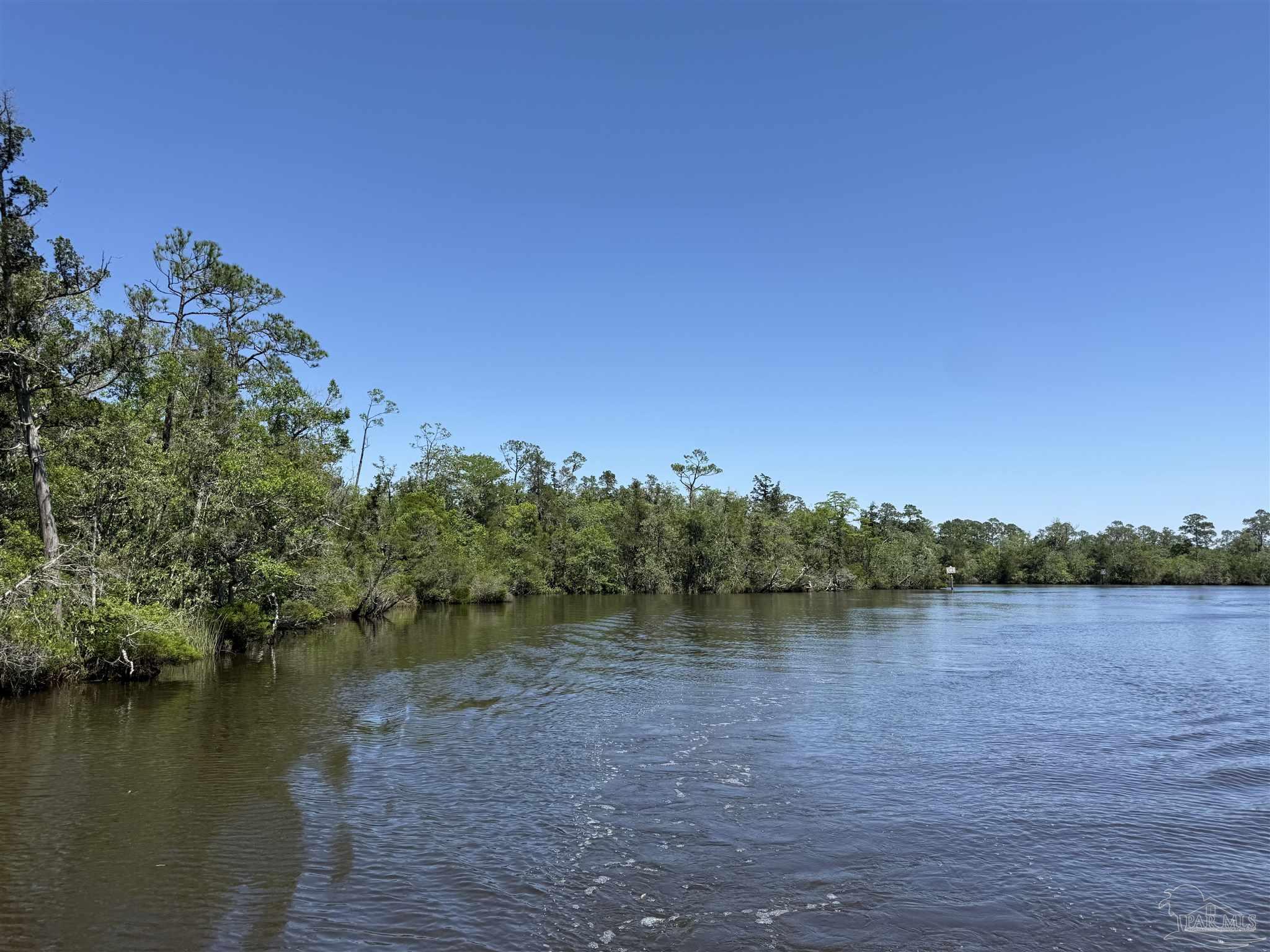 0 Broad Street Milton, FL 32570 - Photo 20 of 28 a view of a lake with houses in background